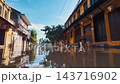 flooded city or town with buildings submerged in overflow water and mud, village underwater after heavy tropical rain and typhoon, consequences with dirt on the street 4k 143716902