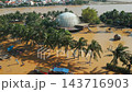 flooded city or town with buildings submerged in overflow water and mud, village underwater after heavy tropical rain and typhoon, consequences with dirt on the street, aerial drone view 4k 143716903