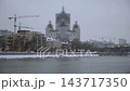Winter Riverfront Cityscape With Cathedral Under Renovation, Bridge And Modern Waterfront Buildings. 143717350