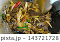 Tender beef slices are simmered in a rich, red savory sauce inside a wok. This colorful and flavorful dish is a classic favorite in traditional Malay cuisine. 143721728