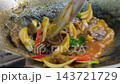Tender beef slices are simmered in a rich, red savory sauce inside a wok. This colorful and flavorful dish is a classic favorite in traditional Malay cuisine. 143721729