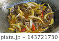 Tender beef slices are simmered in a rich, red savory sauce inside a wok. This colorful and flavorful dish is a classic favorite in traditional Malay cuisine. 143721730