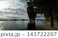 A beautiful silhouette at sunset by the tranquil water, capturing the magic of natures beauty 143722207