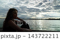 A Reflective Mood Experienced by the Water During the Beautiful Time of Dusk at Twilight 143722211