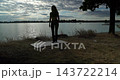 A Graceful Yoga Pose is being performed by the Serene Lake during a Beautiful Sunset 143722214