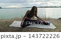 Graceful Stretching Exercises by the Tranquil Water, Embracing Natures Beauty and Serenity 143722226