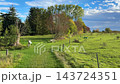 Autumn landscape with an open field and forest in the distance 143724351