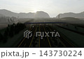 3-lane highway traffic and overpass with sunset view 143730224