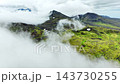 Aerial view of clouds sweeping across mossy volcanic highlands, revealing emerald plateaus, Iceland 143730255