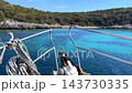 View from the bow of a boat sailing toward a secluded bay with turquoise waters and rocky hills near Bodrum, Turkey. High quality 4k footage 143730335
