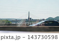 Cable stayed bridge over a river in an urban landscape view from a car 143730598