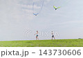 Boy and girl walking barefoot with kites on green algae shore slow motion barefoot 143730606