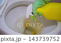 Spraying a toilet bowl with a cleaning solution. Clean toilet 143739752