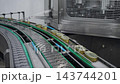 Canned mussels moving on a conveyor belt in a cannery 143744201