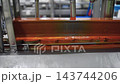 Automated cannery production line filling mussel cans with sauce 143744206