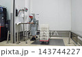 Woman working in a razor clam cannery weighing seafood 143744227
