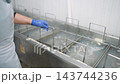 Female worker processing razor clams in a canning factory 143744236