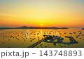 A breathtaking aerial view of Chalong Bay Marina in Phuket, Thailand, captured during sunrise with golden reflections across the calm Andaman Sea and hundreds of anchored boats. A breathtaking aerial view of Chalong Bay Marina in Phuket, Thailand, captured during sunrise with golden reflections across the calm Andaman Sea and hundreds of anchored boats. 143748893