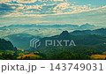 A breathtaking aerial view of Baan Jabo mountain village in Mae Hong Son, surrounded by misty valleys, dramatic peaks, and warm sunrise light creating a peaceful atmosphere. A breathtaking aerial view of Baan Jabo mountain village in Mae Hong Son, surrounded by misty valleys, dramatic peaks, and warm sunrise light creating a peaceful atmosphere. 143749031