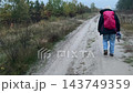 Woman tourist hiking with backpack in forest Woman tourist hiking with backpack in forest 143749359