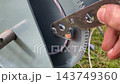 Tightening bolt with wrench on metal winch Tightening bolt with wrench on metal winch 143749360