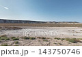 Photographed while driving across a plain dotted with Mangystau shrubs and a long stretch of pale cliffs. 143750746