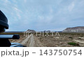 Dashcam footage of a vehicle traveling along a deeply rutted, unpaved road towards the pale-colored plateau of Mangystau. 143750754
