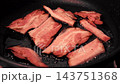 Frying Bacon Slices in a Pan. Crispy Pieces of Delicious Red Thin Smokey Bacon Fried in a Hot Skillet. Traditional Breakfast. Smoked Bacon Rasher or Strip Being Cooked. Grill. Fat High Calorie Food. 143751368