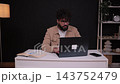 Stressed man experiencing headache working on laptop 143752479