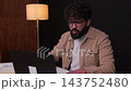 Excited male freelancer celebrating success at laptop 143752480