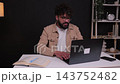 Successful freelancer celebrating victory using laptop at home office 143752482
