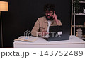 Young businessman multitasking working late at night 143752489