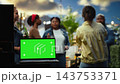 Isolated green screen chroma key on laptop at fun rooftop party outdoors, social gathering with people dancing. Replaceable blank display with group of friends socializing. 143753371