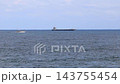 A large ship and two smaller ships sailing near the horizon. A large ship and two smaller ships sailing near the horizon. 143755454