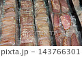 Rows of sliced deli meats arranged in sealed plastic trays, showing varied pink and beige cold cuts for grocery retail, food packaging, catering, supermarket display, and culinary background video Rows of sliced deli meats arranged in sealed plastic trays, showing varied pink and beige cold cuts for grocery retail, food packaging, catering, supermarket display, and culinary background video 143766301