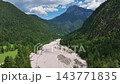 Robanov kot valley in the Slovenian alps. in European Alps. Panoramic aerial shot over vast rolling green hills and dense forests in Slovenia. 143771835