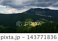 Solcava Panoramic Road in Summer in Slovenia, Warm golden sunlight grazes mountain peak and distant farms. 143771836