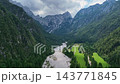 Robanov kot valley in the Slovenian alps. in European Alps. Panoramic aerial shot over vast rolling green hills and dense forests in Slovenia. 143771845