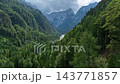 Robanov kot valley in the Slovenian alps. in European Alps. Panoramic aerial shot over vast rolling green hills and dense forests in Slovenia. 143771857