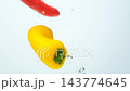 Fresh colorful bell peppers falling into clear water in slow motion video 143774645