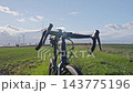 Gravel bike with flashing front light standing in a field 143775196