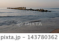 Sunset at Baltic sea, seascape with wooden breakwaters and seagulls, nobody 143780362