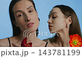 Models showcasing floral fashion in a vibrant studio setting 143781199