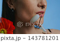 Beauty enthusiast demonstrates facial roller technique for glowing skin 143781201