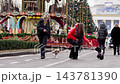 Dogs and people enjoying a festive winter day at a park 143781390