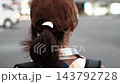 A woman's back as she walks through the city at dusk (slow motion) 143792728