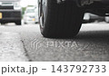 Close-up of an asphalt road and a car tire 143792733