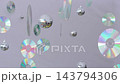 Iridescent discs and miniature disco balls rotate gently in whimsical suspended display. Rainbow reflections shimmer across lavender setting, suggesting nostalgic dance party decor. 143794306