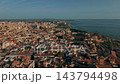 Sunlit Aerial View Of Mallorca Harbor District Showing Dense Terracotta Old Town Roofs, Historic Architecture, Waterfront Road, Shoreline And Blue Bay 143794498