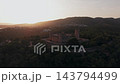 Sunrise Aerial Over Mallorca Castle Shows Quiet Hilltop Walls, Dense Trees And Far Coast. Soft Light Creates Peaceful 143794499